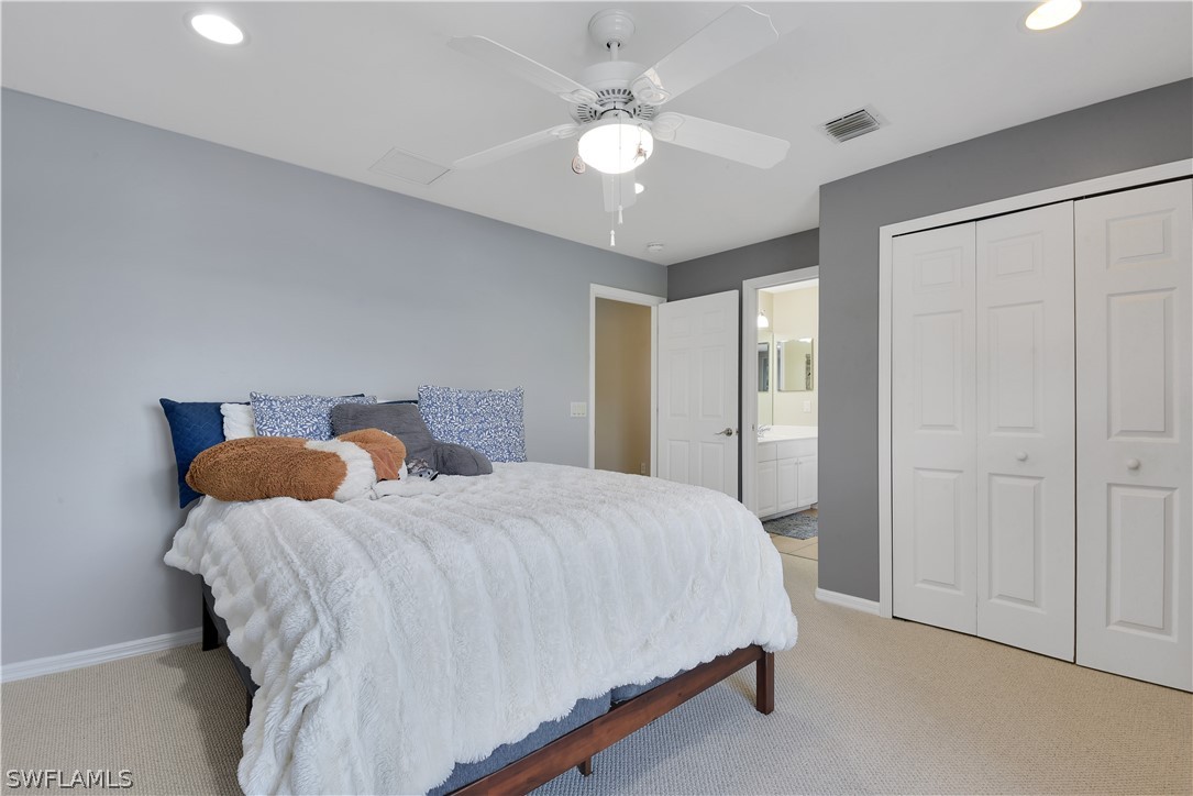 12834 Timber Ridge Drive Fort Myers, FL 33913 - Photo 19 of 31 a bedroom with a bed and a chandelier
