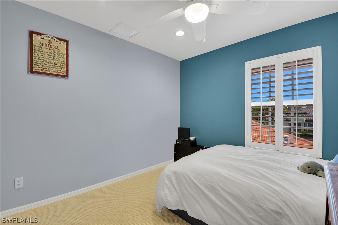 12834 Timber Ridge Drive Fort Myers, FL 33913 - Photo 26 of 31 a bedroom with a bed and a window