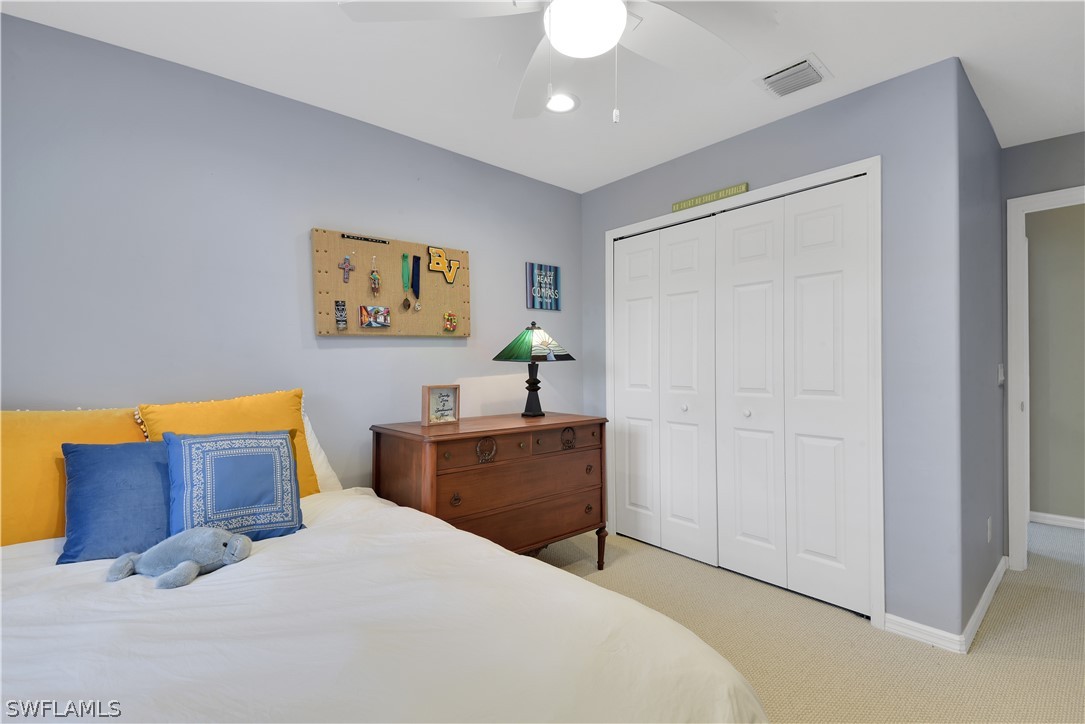 12834 Timber Ridge Drive Fort Myers, FL 33913 - Photo 27 of 31 a bedroom with a bed and a painting on the wall