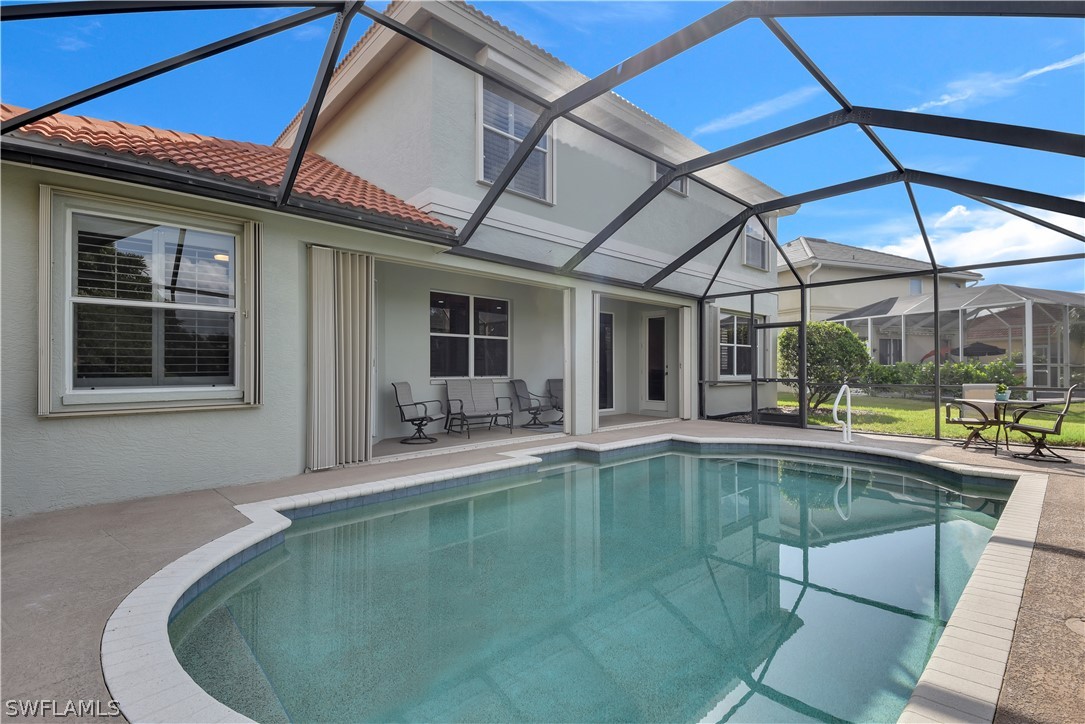 12834 Timber Ridge Drive Fort Myers, FL 33913 - Photo 30 of 31 a view of a swimming pool with a lounge chairs