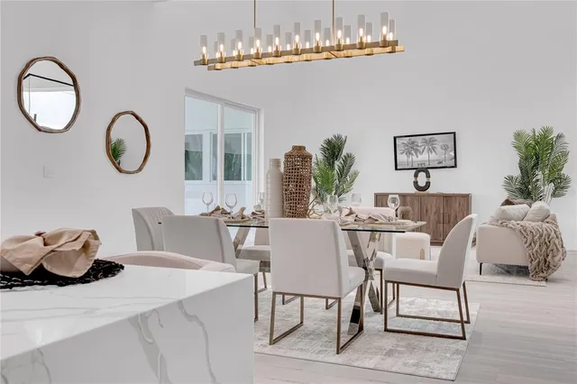 a dining room with furniture a chandelier and wooden floor