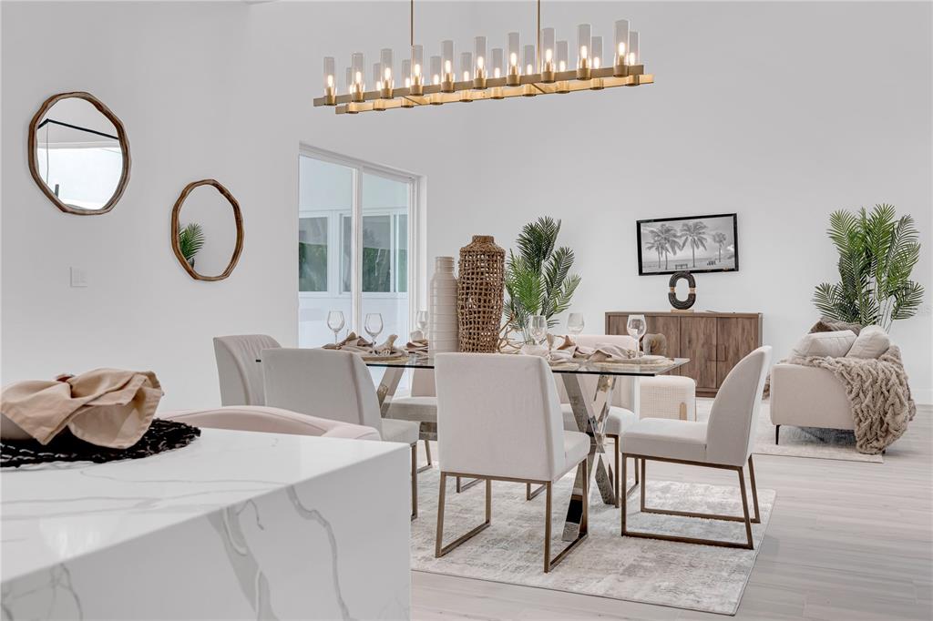 436 East 7th Avenue Windermere, FL 34786 - Photo 12 of 27 a dining room with furniture a chandelier and wooden floor