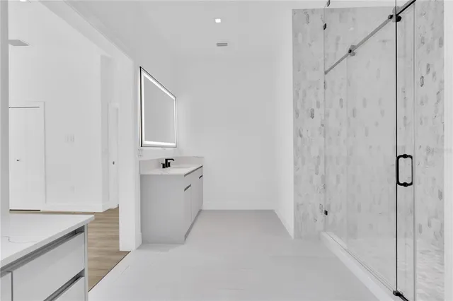 a bathroom with a bathtub sink and mirror