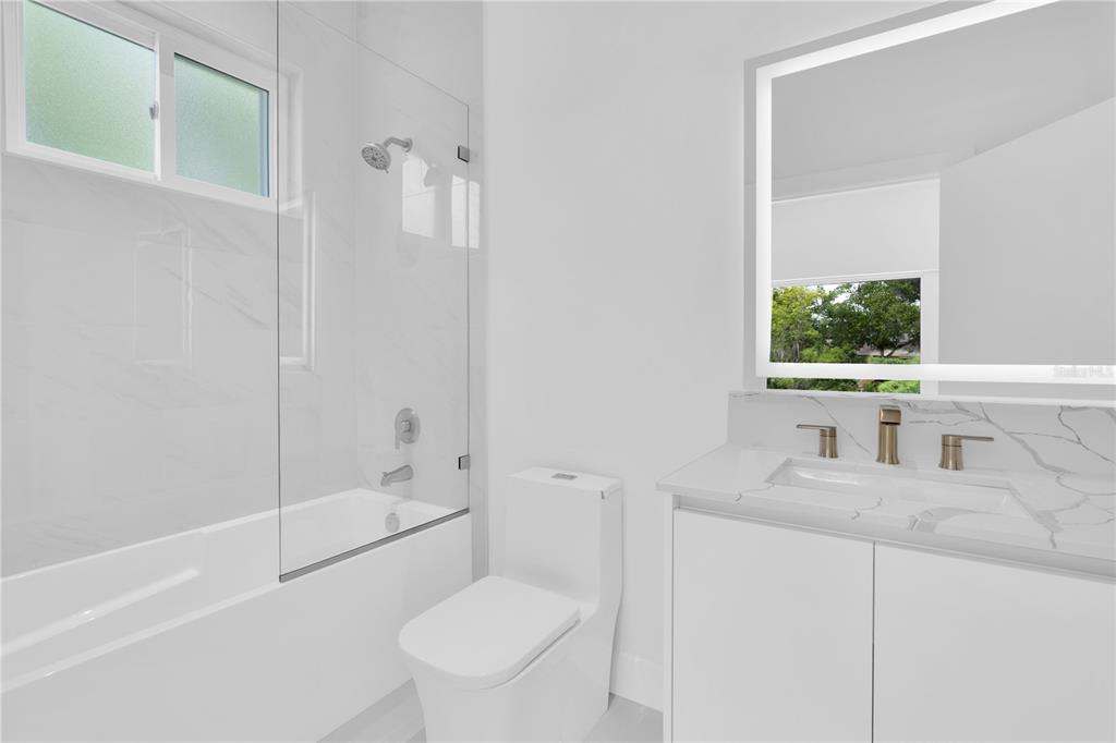 436 East 7th Avenue Windermere, FL 34786 - Photo 18 of 27 a bathroom with a granite countertop sink toilet and shower