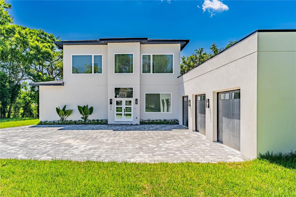 436 East 7th Avenue Windermere, FL 34786 - Photo 3 of 27 a front view of a house with a yard and potted plants