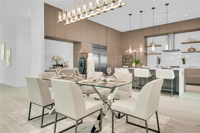 a view of a dining room with furniture a chandelier and wooden floor