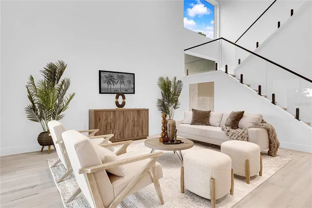 a living room with furniture a potted plant and a lamp