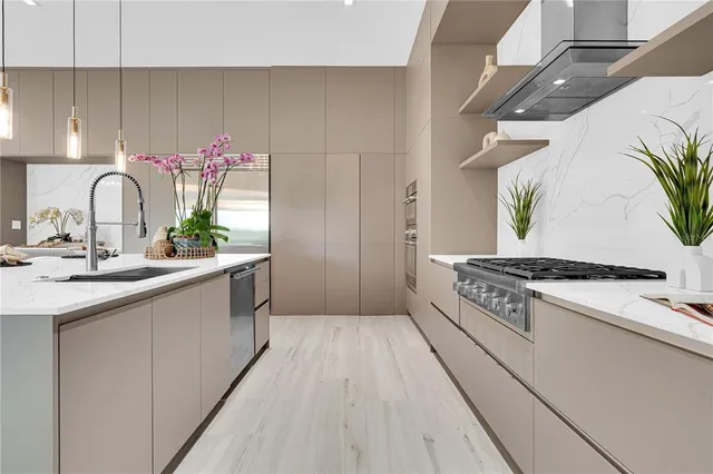 a kitchen with stainless steel appliances granite countertop a stove a sink dishwasher and a refrigerator