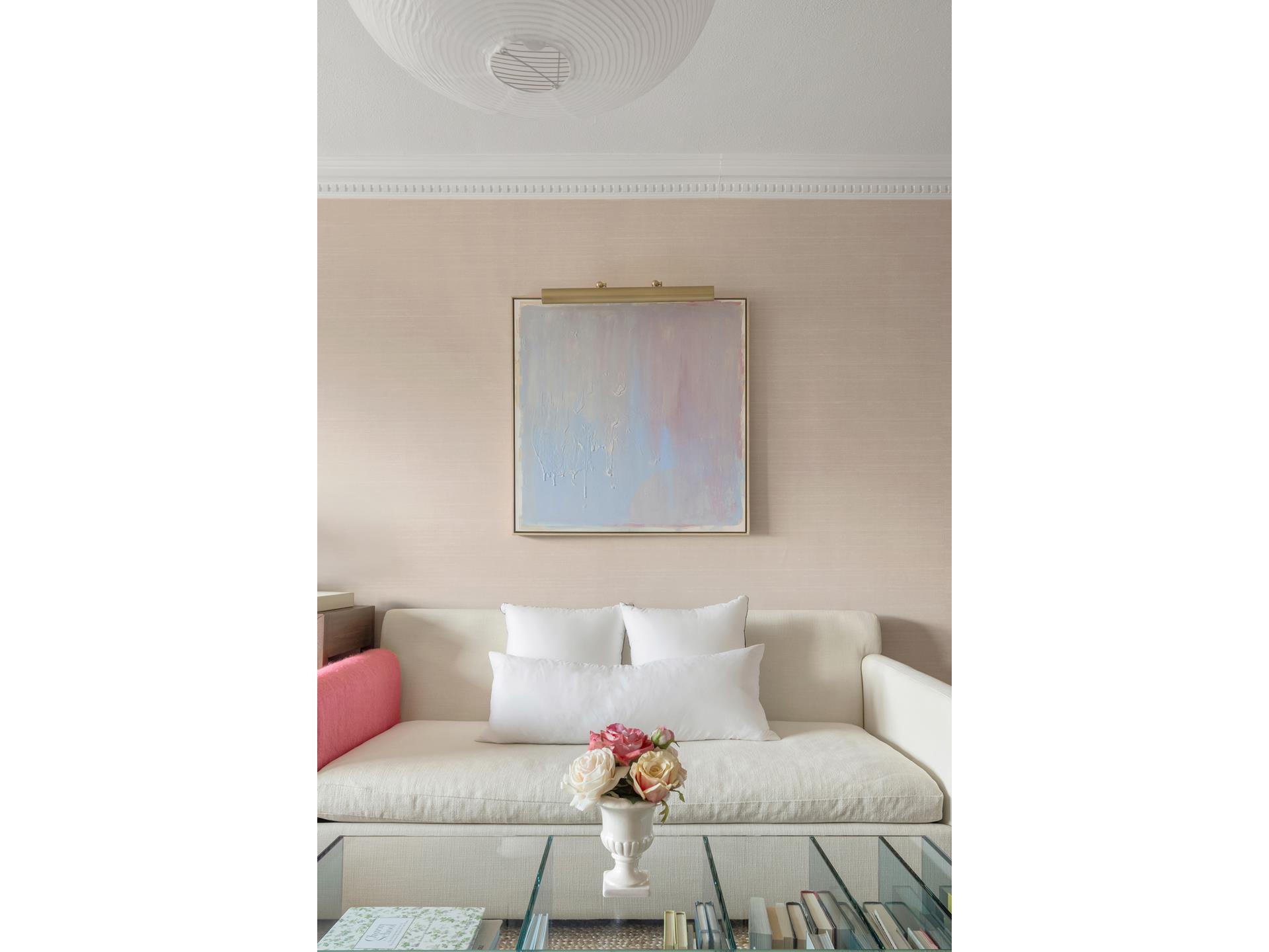 101 West 12th Street, Unit 12E Manhattan, NY 10011 - Photo 4 of 9 a living room with a couch and a table