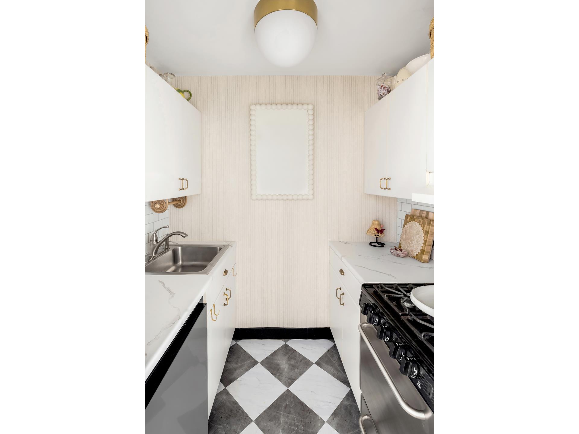 101 West 12th Street, Unit 12E Manhattan, NY 10011 - Photo 5 of 9 a kitchen with a sink and cabinets
