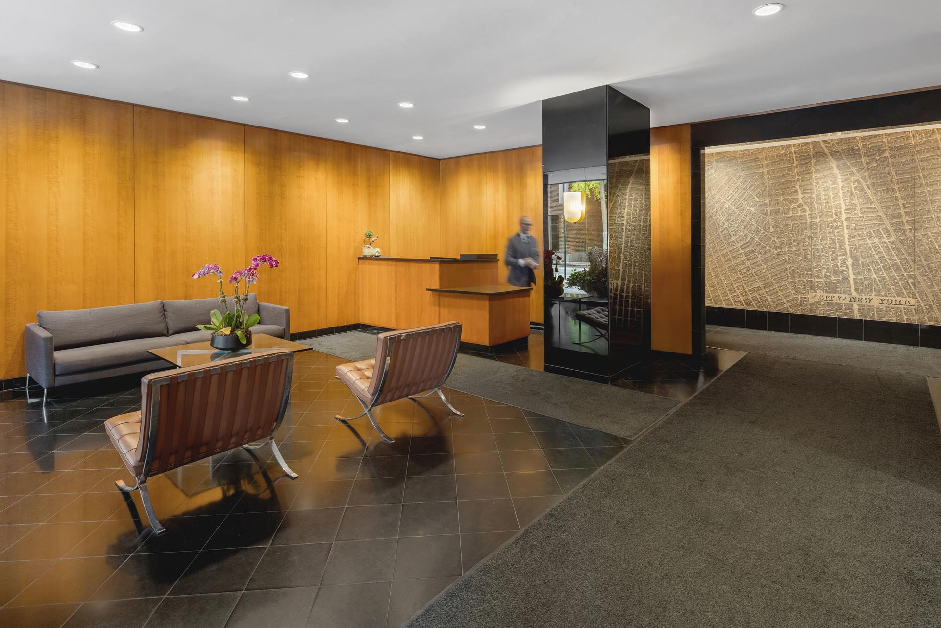 101 West 12th Street, Unit 12E Manhattan, NY 10011 - Photo 8 of 9 a view of a livingroom with furniture and a window