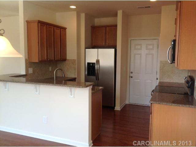 78174 Rillstone Drive, Unit 221 Lancaster, SC 29720 - Photo 6 of 16 a kitchen with a refrigerator and a sink