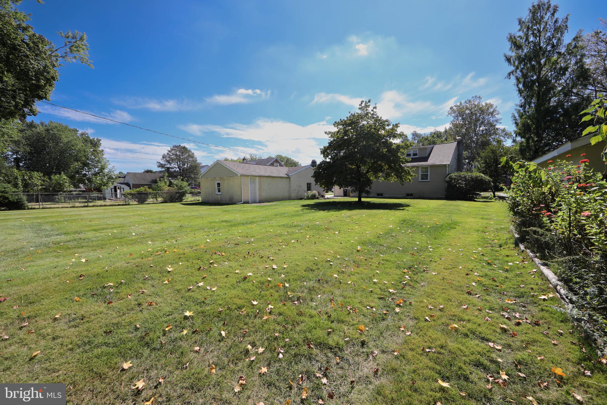 449 Hawarden Road Springfield, PA 19064 - Photo 51 of 60 Spacious yard under a bright blue sky.