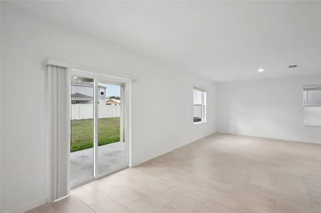 an empty room with windows and entrance