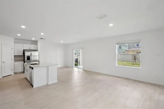 a view of kitchen with stainless steel appliances refrigerator oven and microwave