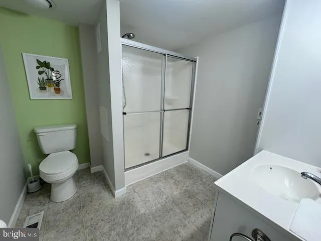 a bathroom with a toilet sink and a shower