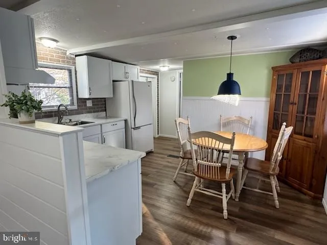 a view of a dining room with furniture and a chandelier