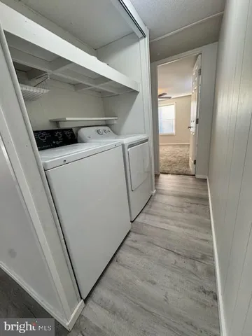 a utility room with cabinets washer and dryer