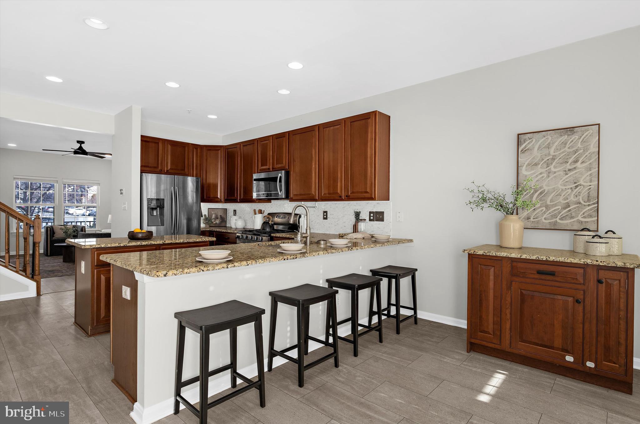 3115 Raking Leaf Drive Abingdon, MD 21009 - Photo 17 of 61 a kitchen with stainless steel appliances granite countertop a table chairs sink refrigerator and cabinets