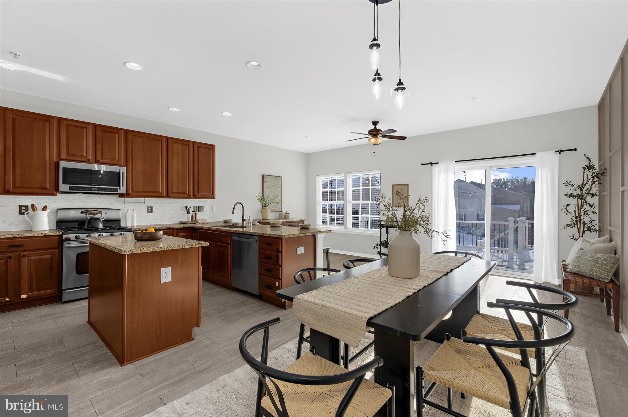 3115 Raking Leaf Drive Abingdon, MD 21009 - Photo 19 of 61 a kitchen with a stove a sink a dining table and chairs