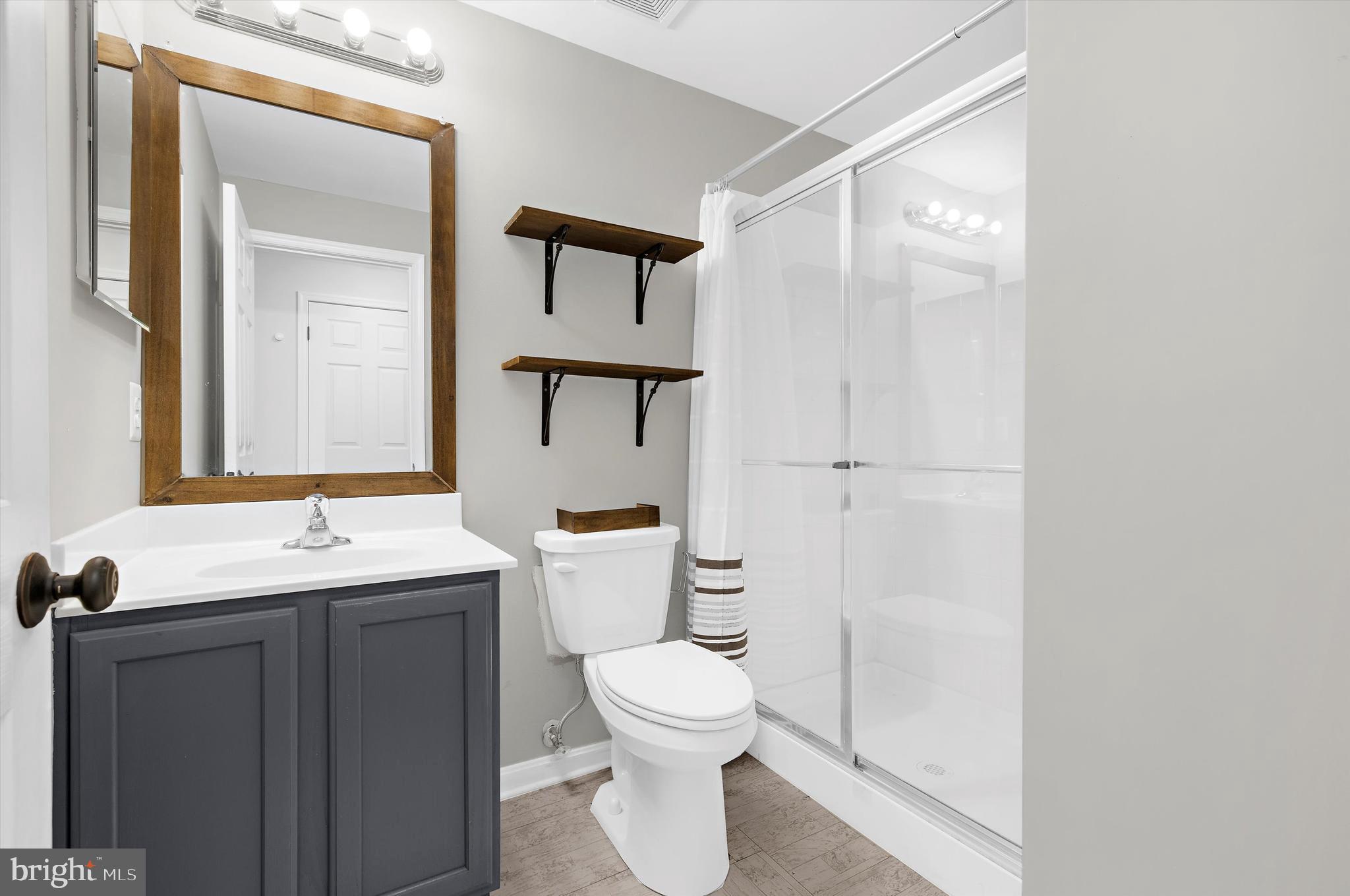 3115 Raking Leaf Drive Abingdon, MD 21009 - Photo 24 of 61 a bathroom with a toilet sink and mirror