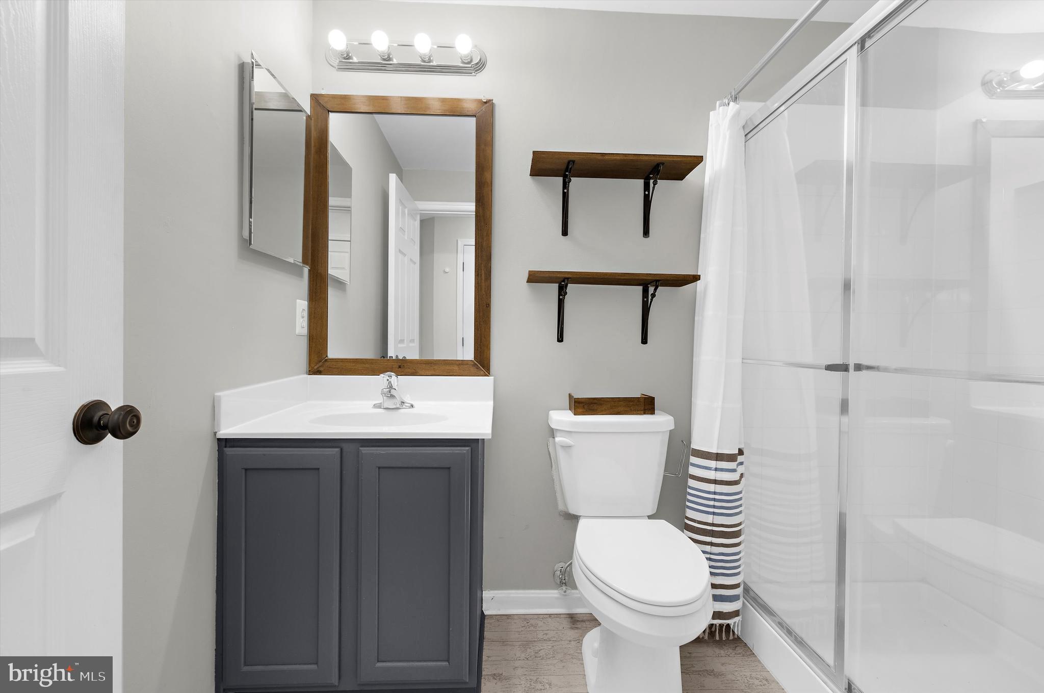 3115 Raking Leaf Drive Abingdon, MD 21009 - Photo 25 of 61 a bathroom with a toilet sink and mirror