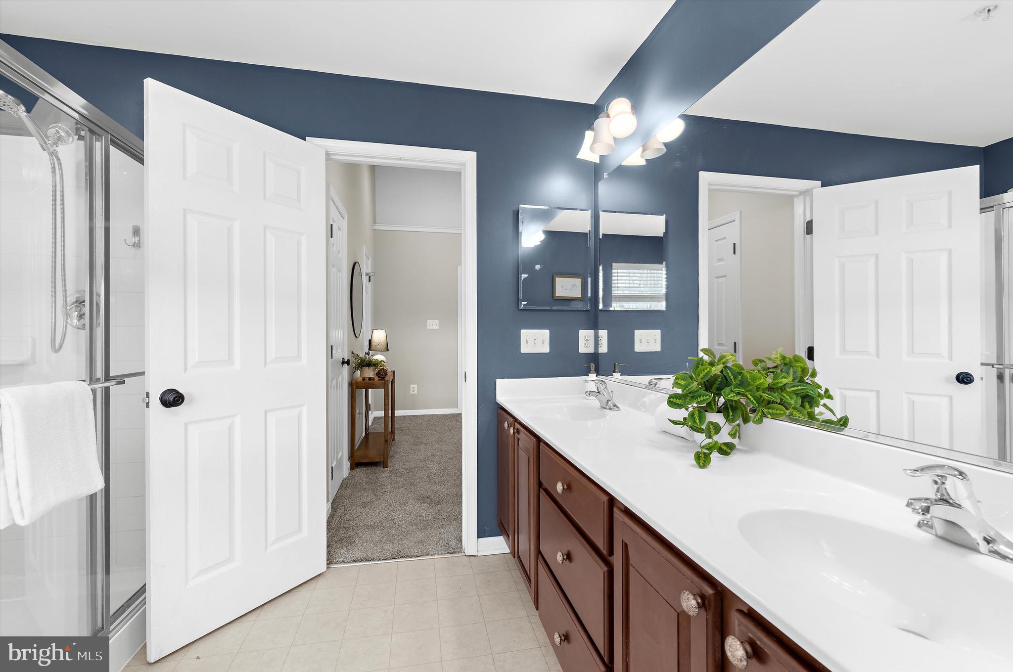 3115 Raking Leaf Drive Abingdon, MD 21009 - Photo 36 of 61 a bathroom with a double vanity sink and a mirror
