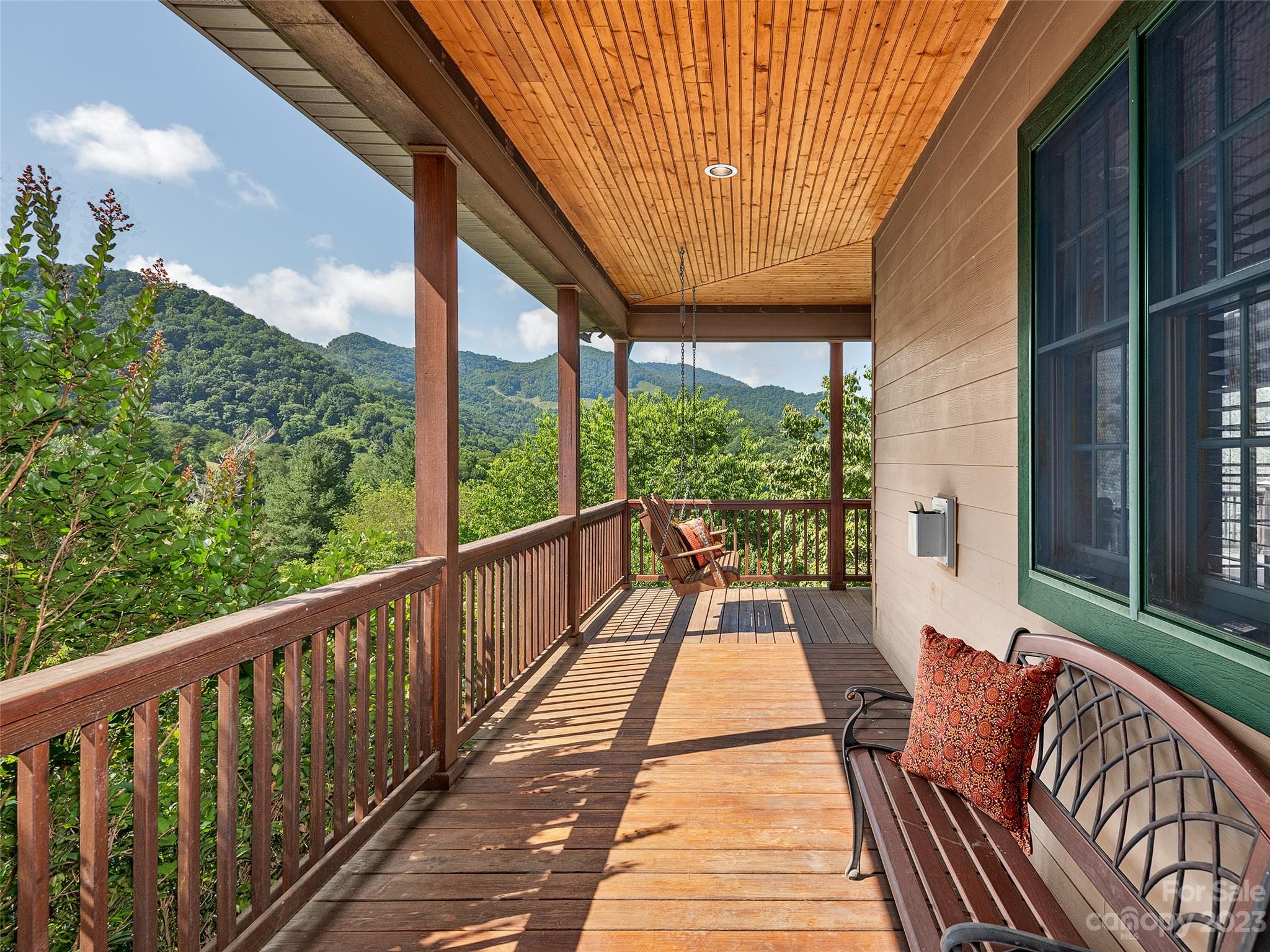 234 Arbor Ridge Clyde, NC 28721 - Photo 14 of 33 a balcony with wooden floor and outdoor seating