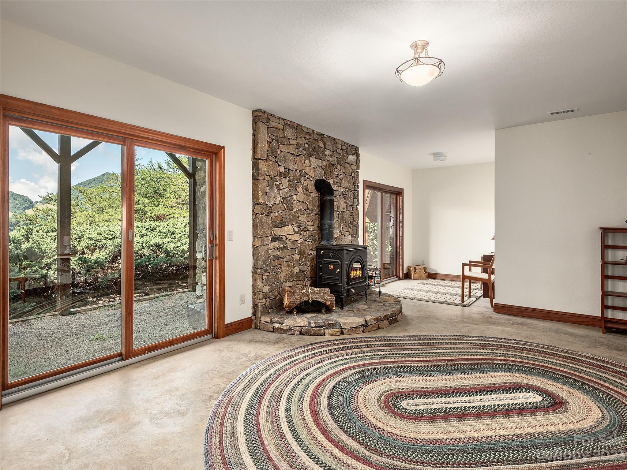 234 Arbor Ridge Clyde, NC 28721 - Photo 21 of 33 a room with furniture and a floor to ceiling window
