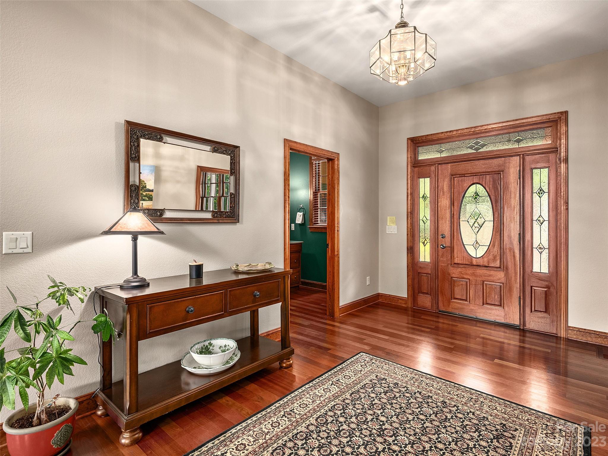 234 Arbor Ridge Clyde, NC 28721 - Photo 3 of 33 a view of a hallway with wooden floor and windows