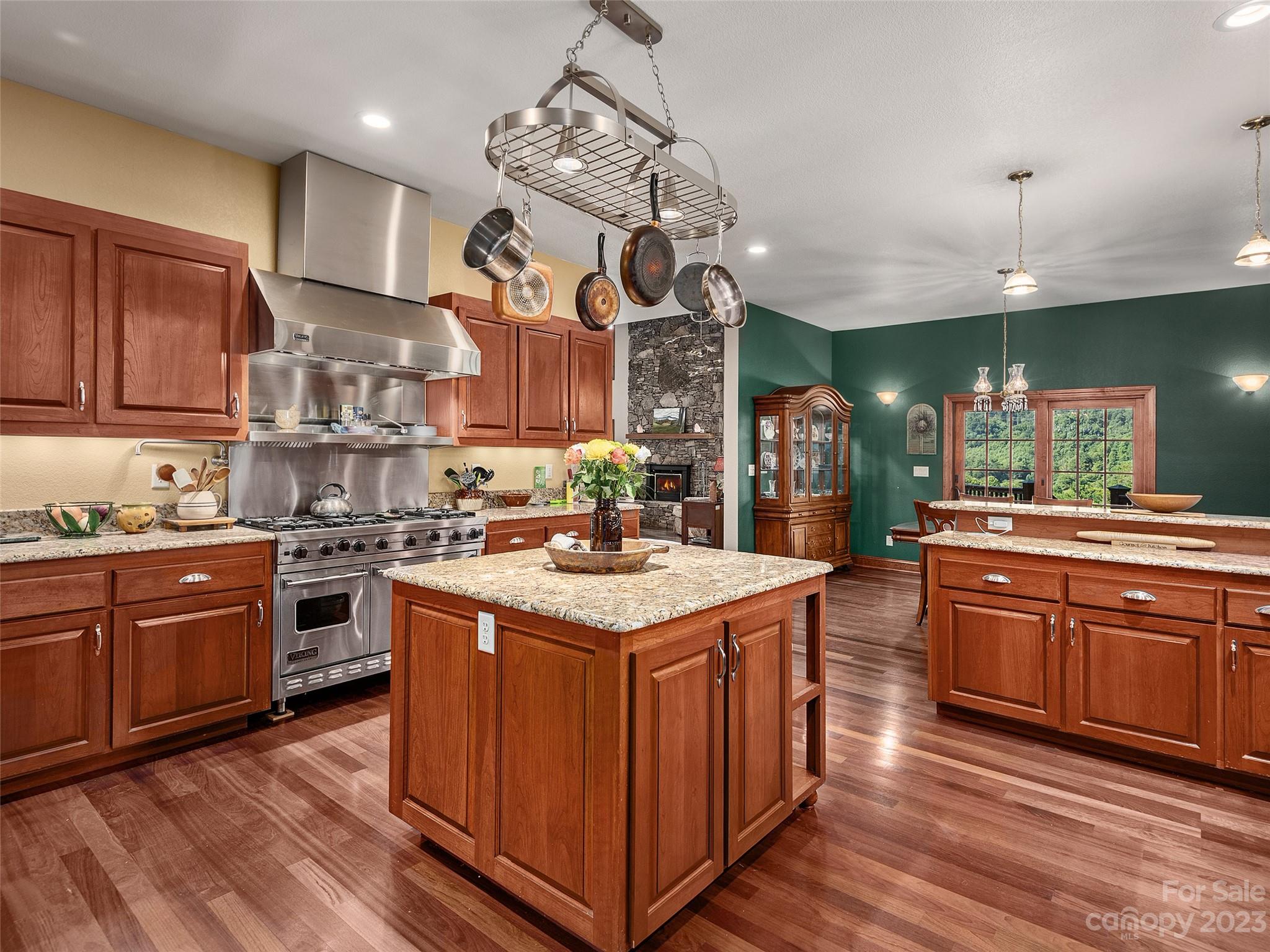 234 Arbor Ridge Clyde, NC 28721 - Photo 8 of 33 a kitchen with stainless steel appliances granite countertop wooden floors and view of living room