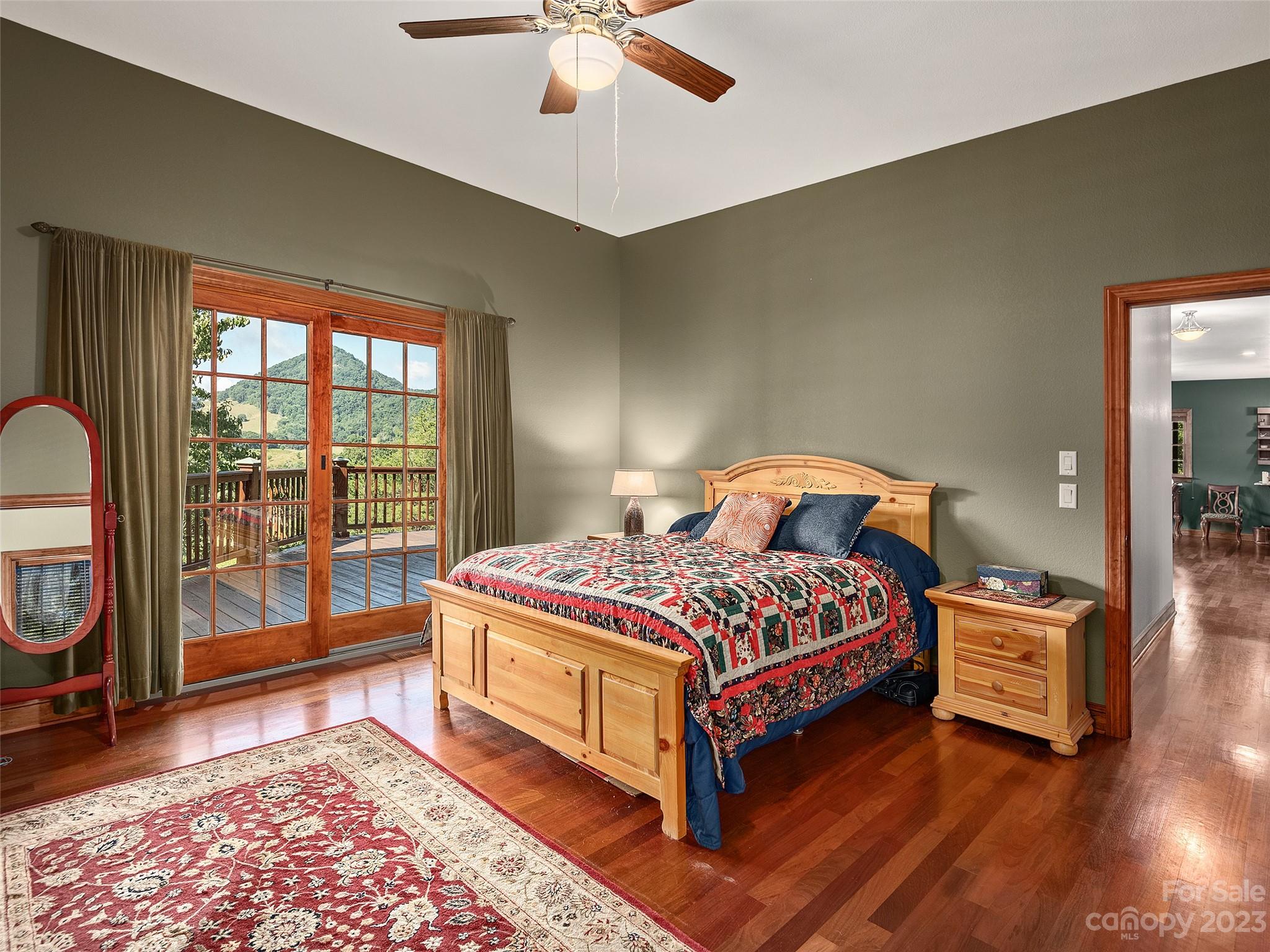 234 Arbor Ridge Clyde, NC 28721 - Photo 10 of 33 a bedroom with a bed and a chandelier