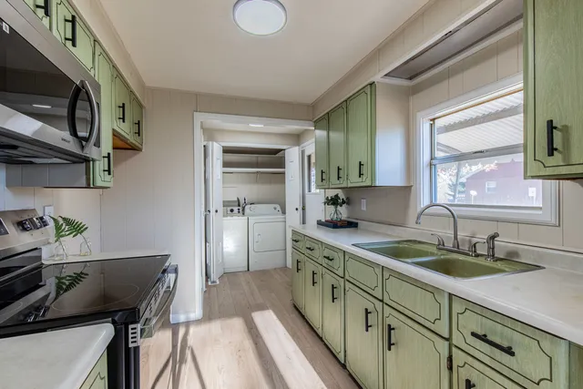 a kitchen with a sink appliances and cabinets