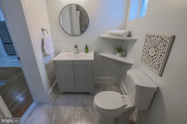 a bathroom with a toilet sink and mirror
