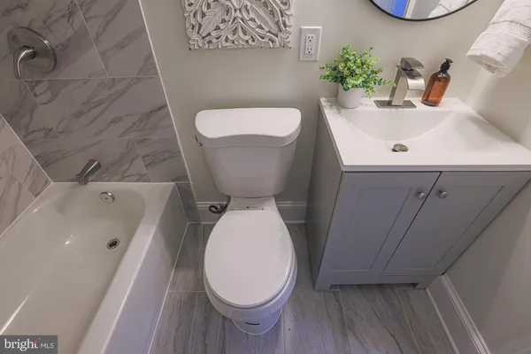 a white toilet sitting next to a bathroom sink