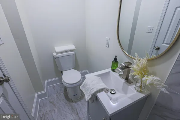 a bathroom with a sink and mirror with toilet