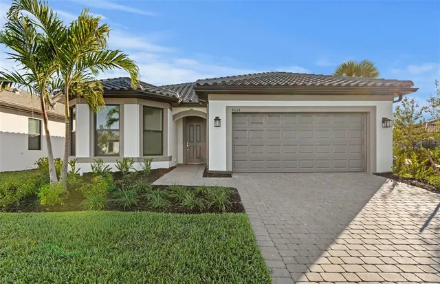 a front view of a house with a garden