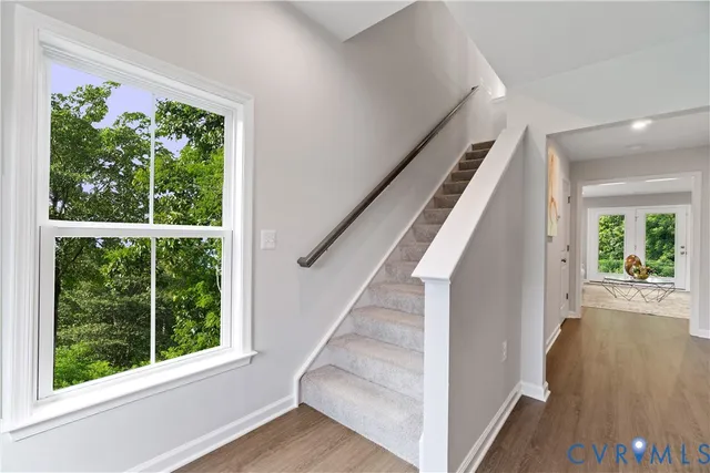 a view of an entryway with wooden floor and door