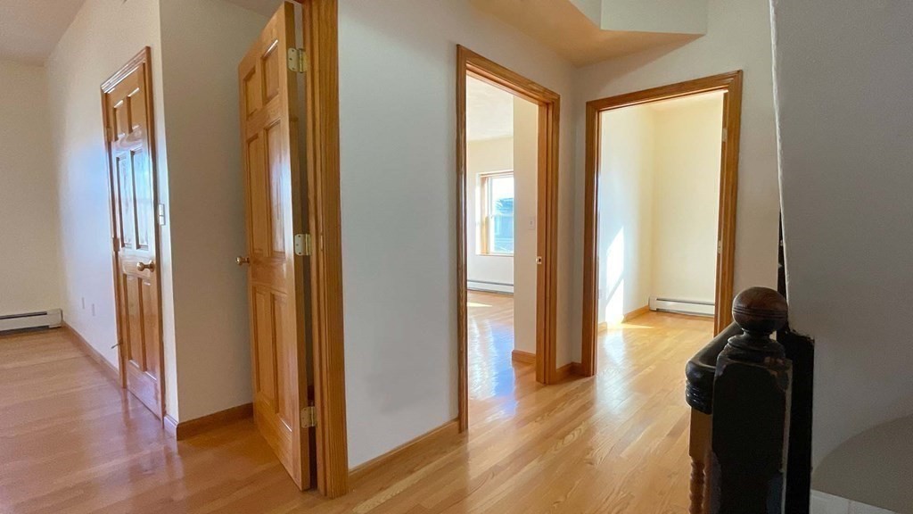21 Parker Street Boston, MA 02129 - Photo 11 of 28 a view of hallway with furniture and wooden floor