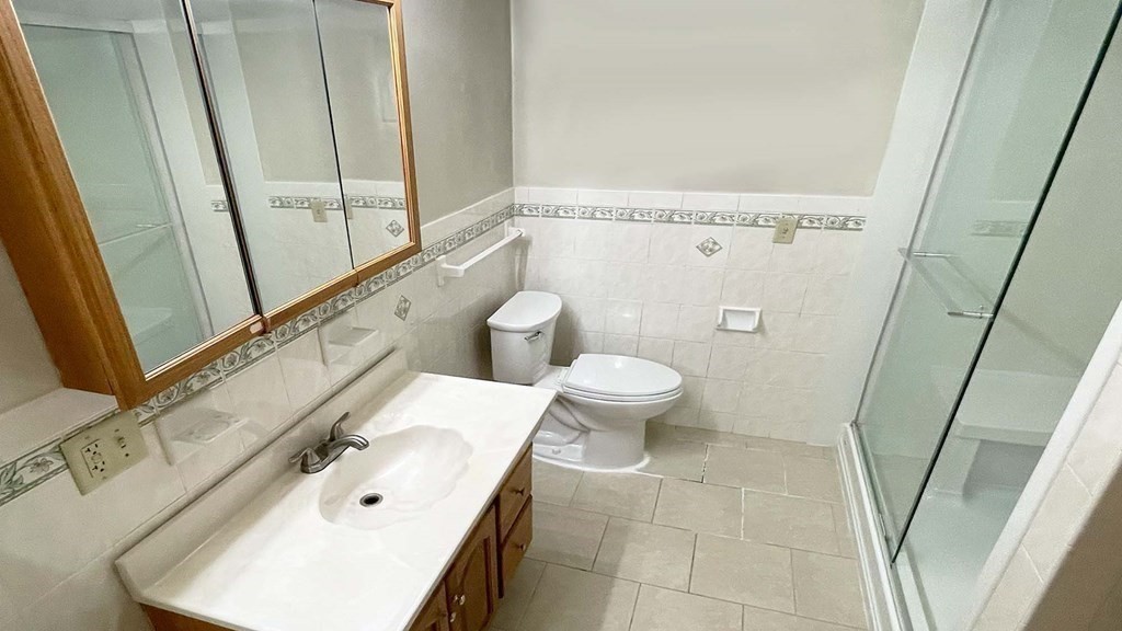 21 Parker Street Boston, MA 02129 - Photo 16 of 28 a bathroom with a sink a toilet and shower