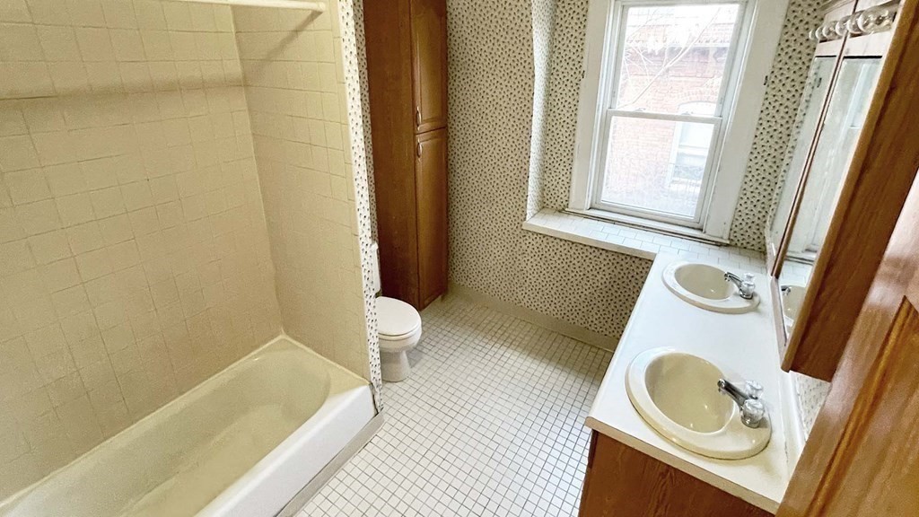 21 Parker Street Boston, MA 02129 - Photo 18 of 28 a bathroom with a sink a toilet and a tub