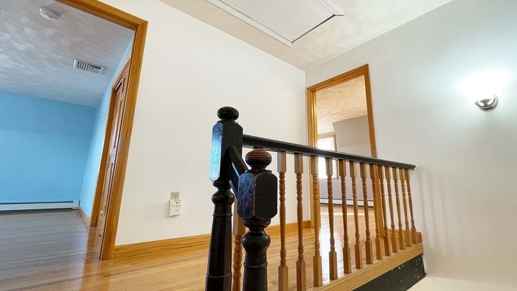 21 Parker Street Boston, MA 02129 - Photo 19 of 28 a view of a hallway with windows and wooden floor