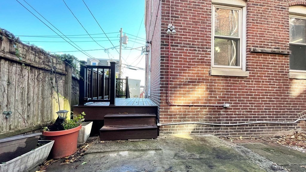 21 Parker Street Boston, MA 02129 - Photo 23 of 28 a view of a patio with a table and chairs and a barbeque