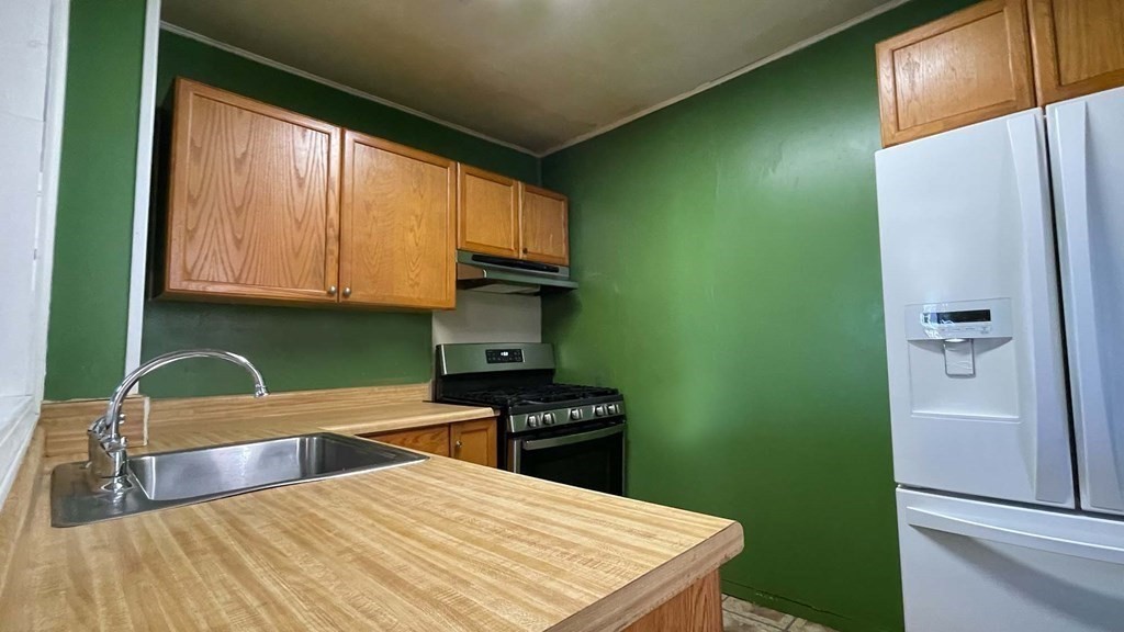 21 Parker Street Boston, MA 02129 - Photo 5 of 28 a kitchen with stainless steel appliances a refrigerator sink and microwave