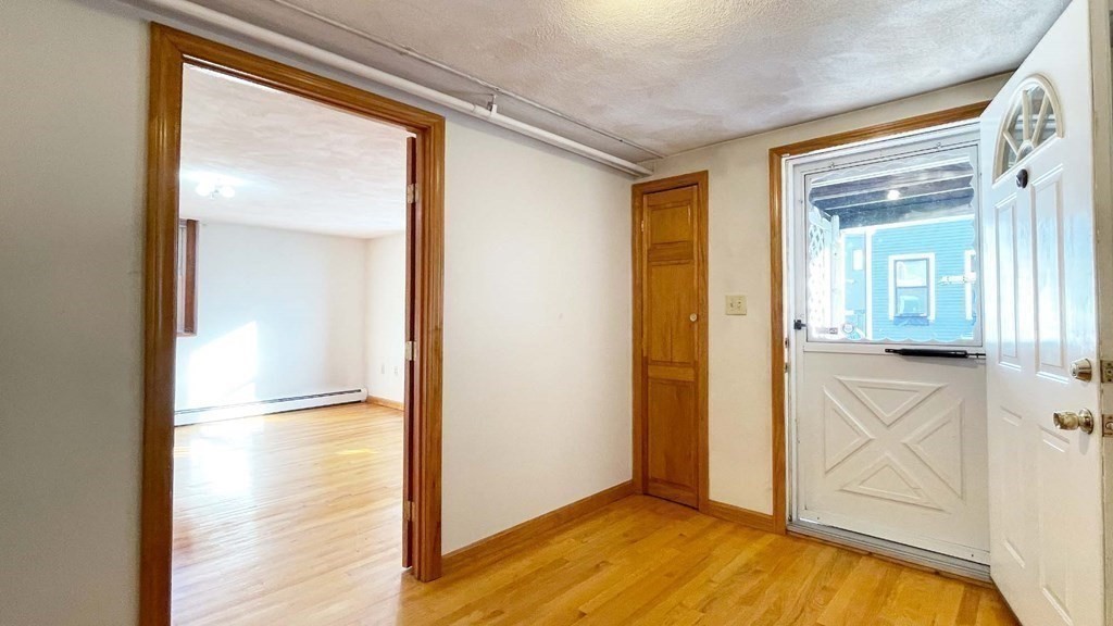 21 Parker Street Boston, MA 02129 - Photo 7 of 28 a view of empty room with wooden floor