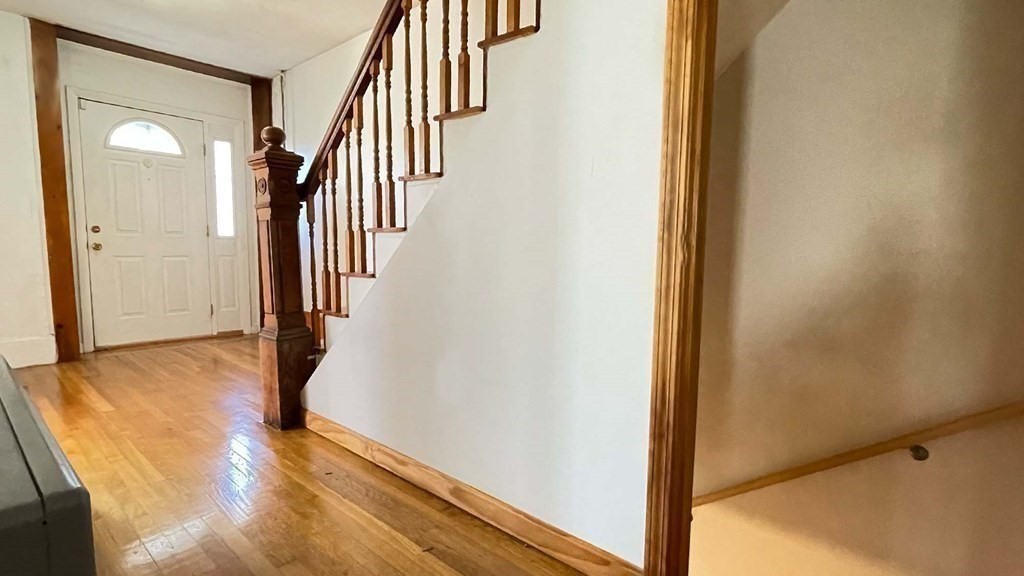 21 Parker Street Boston, MA 02129 - Photo 9 of 28 a view of a hallway with wooden floor and staircase