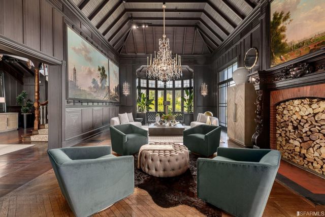 a living room with furniture and a chandelier