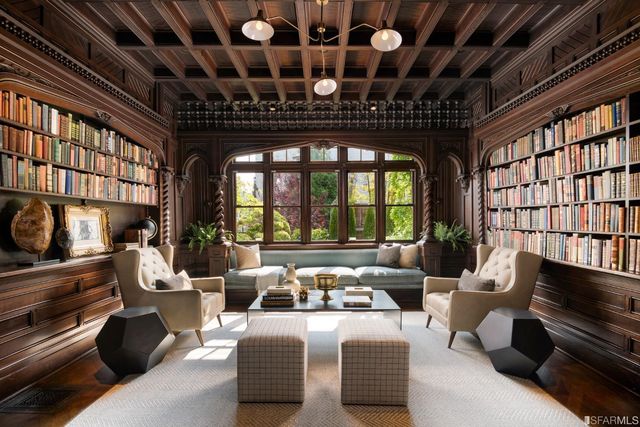 a living room with furniture a chandelier and a fireplace