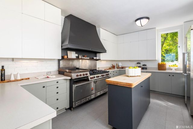 a kitchen with a stove sink and cabinets