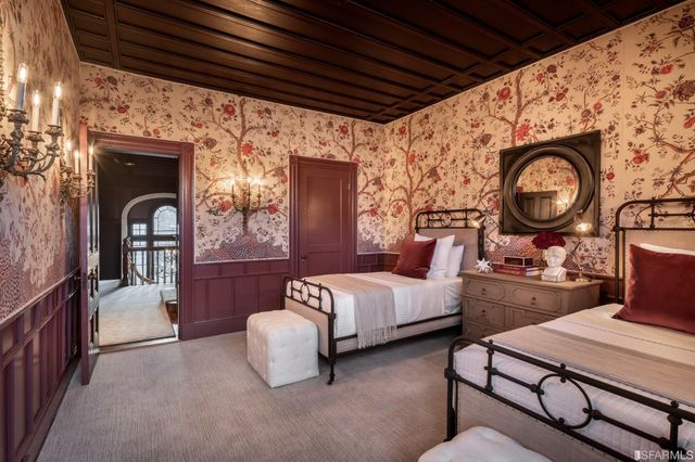 a bedroom with furniture and a large window